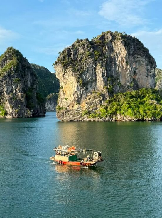 Limestone karsts and a boat on Halong Bay, Vietnam